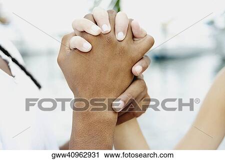 Close-up of two hands clasping each other View Large Photo Image Stock Image - Close-up of two hands clasping each other. Fotosearch