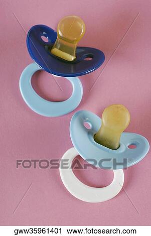 Close-up of two pacifiers View Large Photo Image Stock Image - Close-up of two pacifiers. Fotosearch