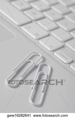 Close-up of two paper clips on a laptop View Large Photo Image Stock Image - Close-up of two paper clips on a laptop. Fotosearch