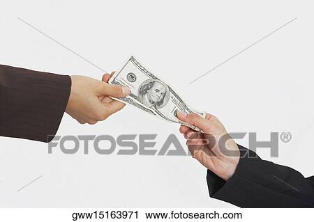 Close-up of two people's hands holding American paper currency View Large Photo Image Stock Image - Close-up of two people's hands holding American paper currency. Fotosearch
