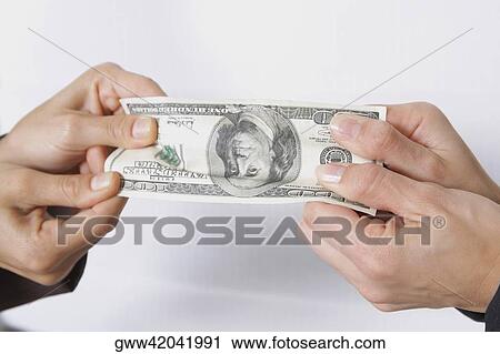 Close-up of two people's hands holding American paper currency View Large Photo Image Stock Image - Close-up of two people's hands holding American paper currency. Fotosearch