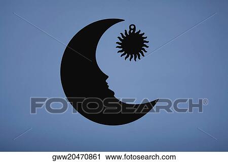Stock Image - Close-up of two sun and moon shaped objects. Fotosearch