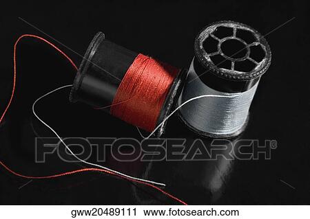 Stock Image - Close-up of two thread spools. Fotosearch