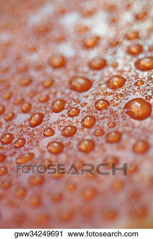 Close-up of water droplets on a red surface View Large Photo Image Stock Image - Close-up of water droplets on a red surface. Fotosearch