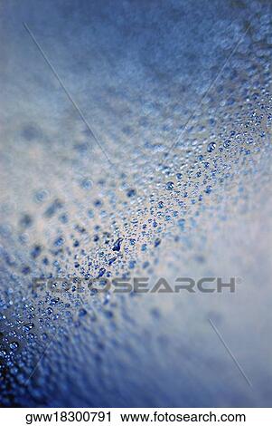 Stock Image - Close-up of water drops on glass. Fotosearch