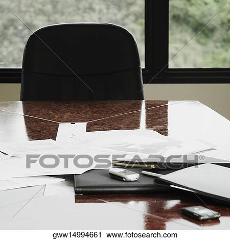 Documents with mobile phone on a table in an office View Large Photo Image Stock Image - Documents with mobile phone on a table in an office. Fotosearch