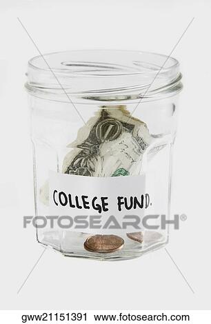 Stock Image - Dollar bills and coins in a jar. Fotosearch
