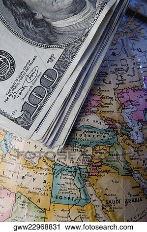 Dollar bills on a globe View Large Photo Image Stock Image - Dollar bills on a globe. Fotosearch