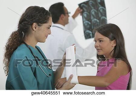Female doctor bandaging a girl's hand View Large Photo Image Stock Image - Female doctor bandaging a girl's hand. Fotosearch