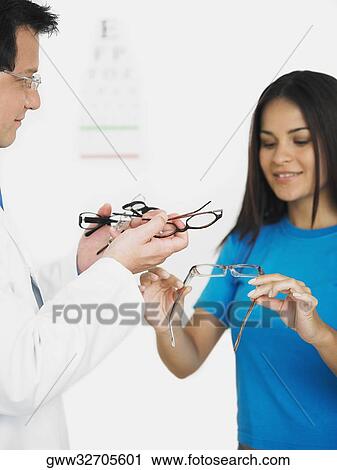 Female patient choosing eyeglasses View Large Photo Image Stock Image - Female patient choosing eyeglasses. Fotosearch