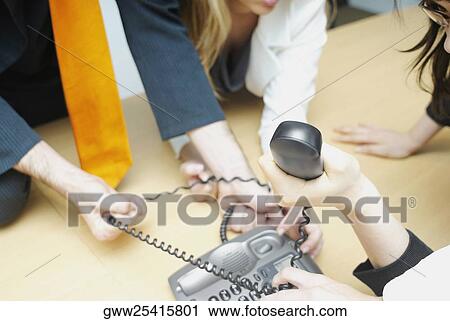 Four business executives fighting for a telephone View Large Photo Image Stock Image - Four business executives fighting for a telephone. Fotosearch