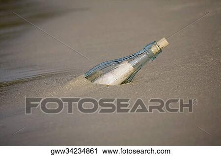 High angle view of a bottle on the beach View Large Photo Image Stock Image - High angle view of a bottle on the beach. Fotosearch