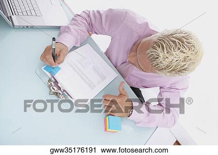 High angle view of a businessman writing on a document View Large Photo Image Stock Image - High angle view of a businessman writing on a document. Fotosearch