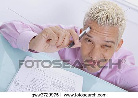 High angle view of a businessman thinking and making a face View Large Photo Image Stock Image - High angle view of a businessman thinking and making a face. Fotosearch