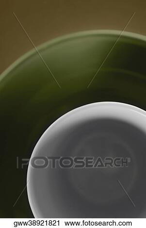 High angle view of a cup in a plate View Large Photo Image Stock Image - High angle view of a cup in a plate. Fotosearch