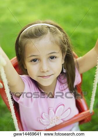 High angle view of a girl on a swing View Large Photo Image Stock Image - High angle view of a girl on a swing. Fotosearch
