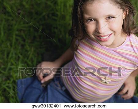 High angle view of a girl smiling View Large Photo Image Stock Image - High angle view of a girl smiling. Fotosearch