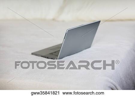 High angle view of a laptop on the bed View Large Photo Image Stock Image - High angle view of a laptop on the bed. Fotosearch