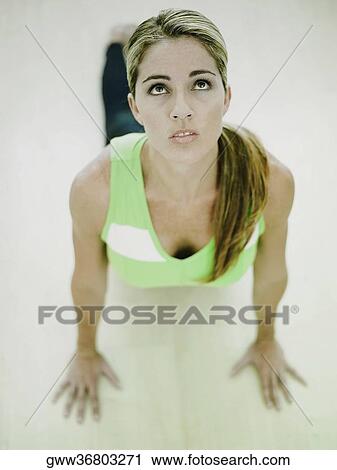 Stock Image - High angle view of a mid adult woman exercising. Fotosearch