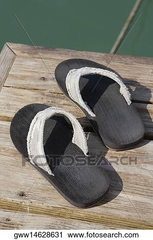 High angle view of a pair of flip-flop on a jetty View Large Photo Image Stock Image - High angle view of a pair of flip-flop on a jetty. Fotosearch