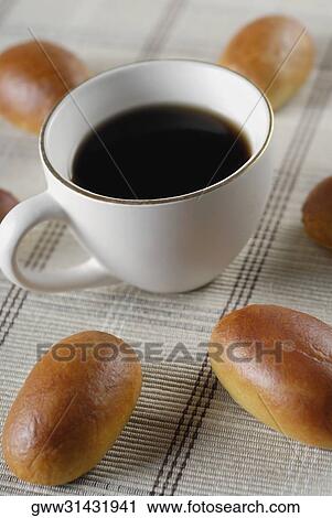 Stock Image - High angle view of a tea cup with buns. Fotosearch