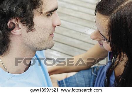 High angle view of a young couple sitting at a pier and looking at each other View Large Photo Image Stock Image - High angle view of a young couple sitting at a pier and looking at each other. Fotosearch