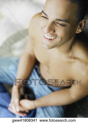 High angle view of a young man smiling View Large Photo Image Stock Image - High angle view of a young man smiling. Fotosearch