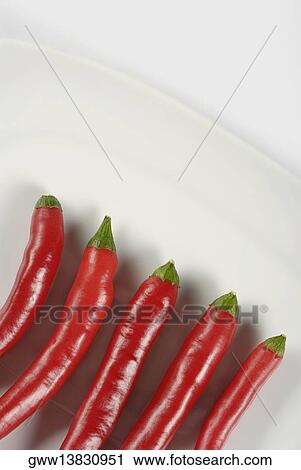High angle view of five red chili peppers in a plate View Large Photo Image Stock Image - High angle view of five red chili peppers in a plate. Fotosearch