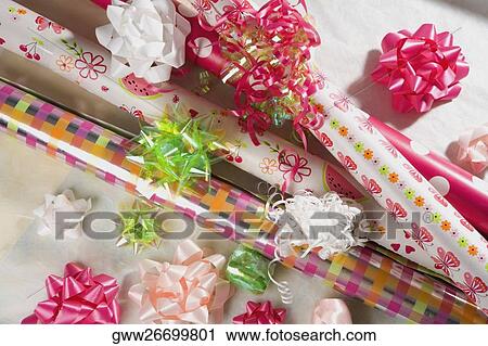 Stock Image - High angle view of ribbons and wrapping paper. Fotosearch