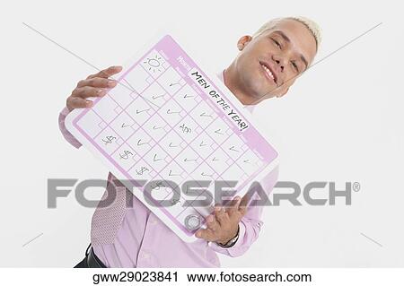 Low angle view of a businessman holding his progress report and smiling View Large Photo Image Stock Image - Low angle view of a businessman holding his progress report and smiling. Fotosearch