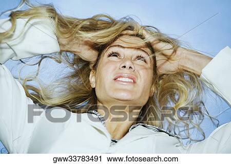 Low angle view of a businesswoman pulling her hair in frustration View Large Photo Image Stock Image - Low angle view of a businesswoman pulling her hair in frustration. Fotosearch