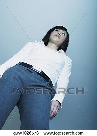 Low angle view of a mid adult woman thinking View Large Photo Image Stock Image - Low angle view of a mid adult woman thinking. Fotosearch