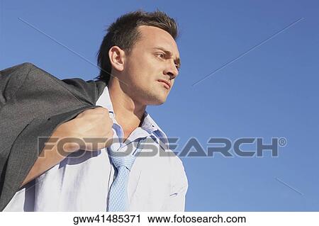 Stock Image - Low angle view of a young woman. Fotosearch