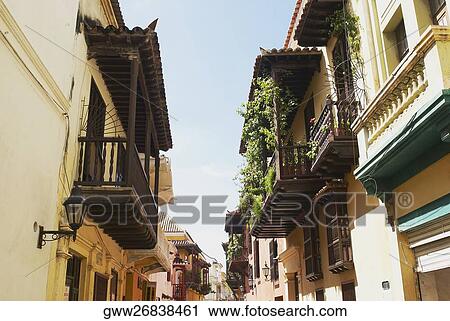 Stock Image - Low angle view of apartments along the street. Fotosearch