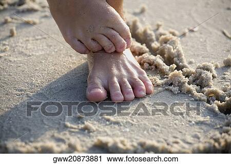Low section view of a person standing on the beach View Large Photo Image Stock Image - Low section view of a person standing on the beach. Fotosearch
