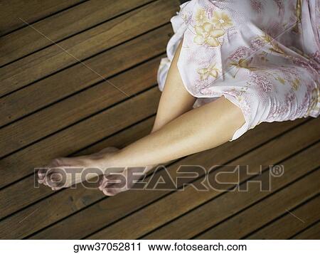 Low section view of a woman lying on the hardwood floor View Large Photo Image Stock Image - Low section view of a woman lying on the hardwood floor. Fotosearch