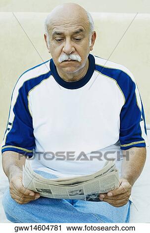 Stock Image - Mature man reading newspaper. Fotosearch