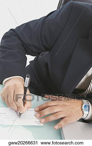 Stock Image - Mid section view of a businessman writing a check. Fotosearch