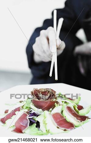 Mid section view of a businesswoman having salad with chopsticks View Large Photo Image Stock Image - Mid section view of a businesswoman having salad with chopsticks. Fotosearch