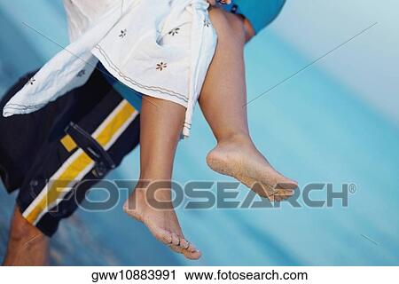 Mid section view of a man carrying a woman on the beach View Large Photo Image Stock Image - Mid section view of a man carrying a woman on the beach. Fotosearch
