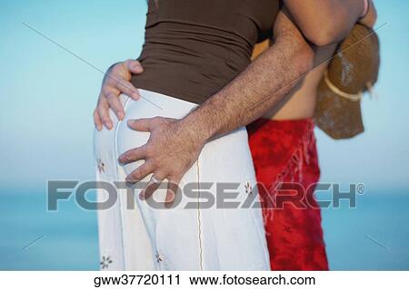 Mid section view of a man embracing a woman View Large Photo Image Stock Image - Mid section view of a man embracing a woman. Fotosearch