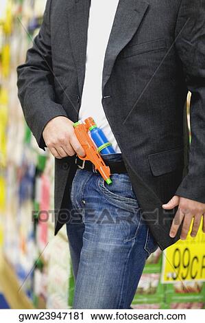 Mid section view of a man holding a squirt gun View Large Photo Image Stock Image - Mid section view of a man holding a squirt gun. Fotosearch