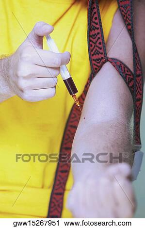 Mid section view of a man injecting a syringe in his arm View Large Photo Image Stock Image - Mid section view of a man injecting a syringe in his arm. Fotosearch
