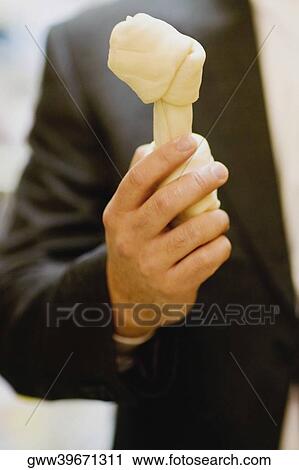 Mid section view of a man showing a dog bone View Large Photo Image Stock Image - Mid section view of a man showing a dog bone. Fotosearch