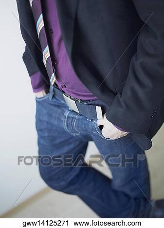 Mid section view of a man standing with his hands in his pockets View Large Photo Image Stock Image - Mid section view of a man standing with his hands in his pockets. Fotosearch