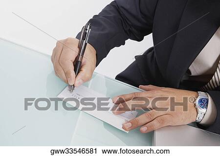 Mid section view of a man writing a check View Large Photo Image Stock Image - Mid section view of a man writing a check. Fotosearch