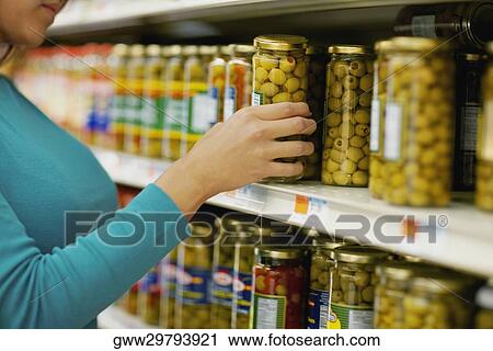 Mid section view of a woman choosing pickles View Large Photo Image Stock Image - Mid section view of a woman choosing pickles. Fotosearch
