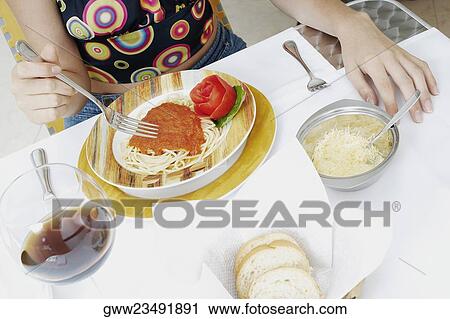 Mid section view of a woman eating View Large Photo Image Stock Image - Mid section view of a woman eating. Fotosearch