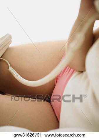 Mid section view of a woman using a telephone View Large Photo Image Stock Image - Mid section view of a woman using a telephone. Fotosearch