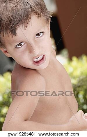 Portrait of a boy clenching his teeth View Large Photo Image Stock Image - Portrait of a boy clenching his teeth. Fotosearch